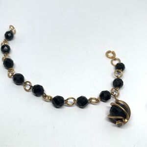Vintage unsigned, gold town black beaded bracelet with dangle